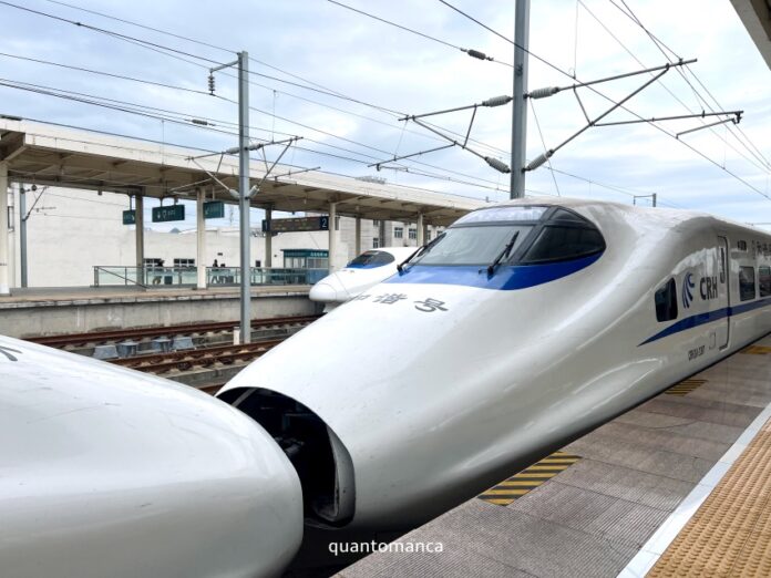Treno ad alta velocità cinese tipo G-Train fermo sulla banchina di una moderna stazione in Cina, con il muso aerodinamico bianco e finestrini scuri
